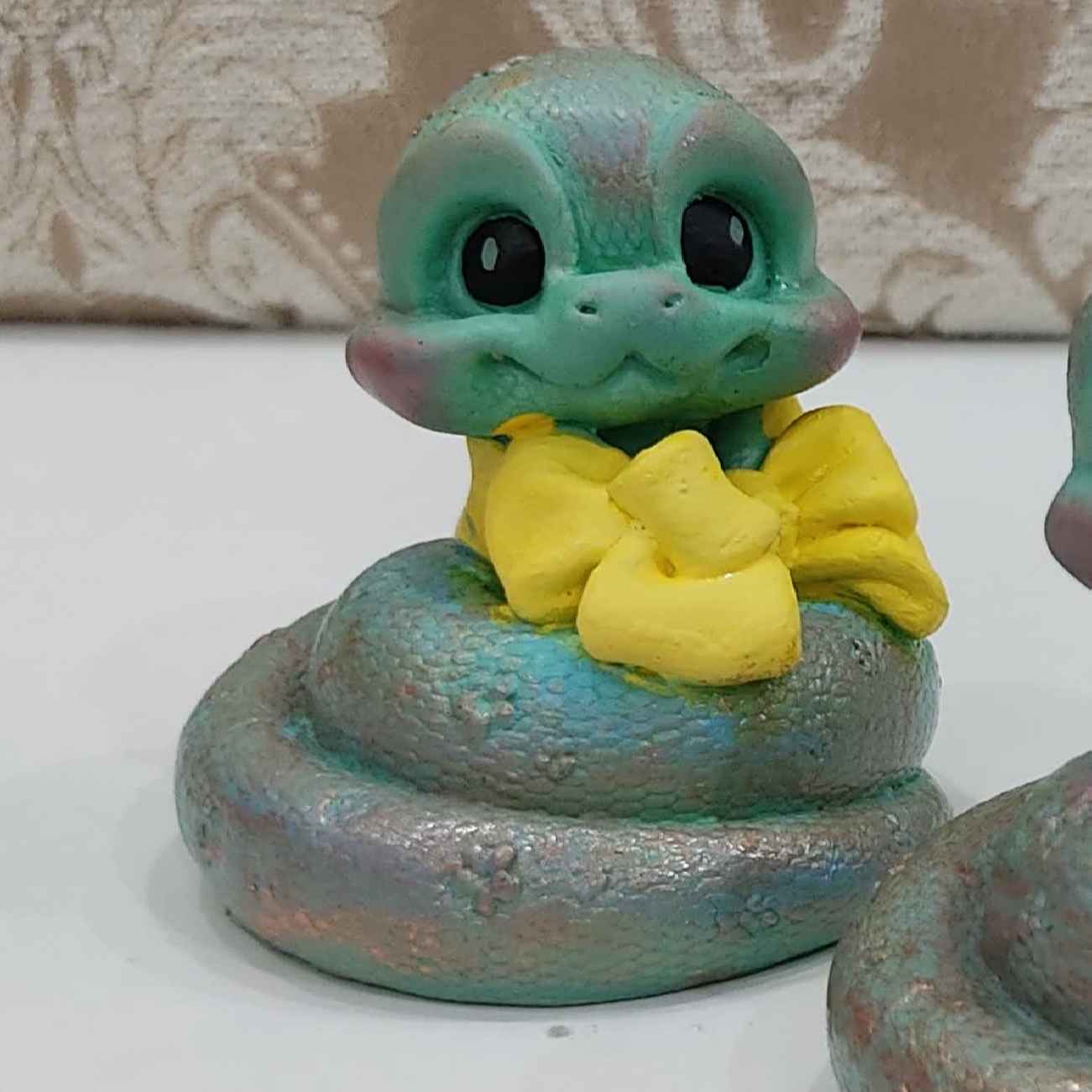 Adorable Snake Figurines with Bows for Nowruz 1404