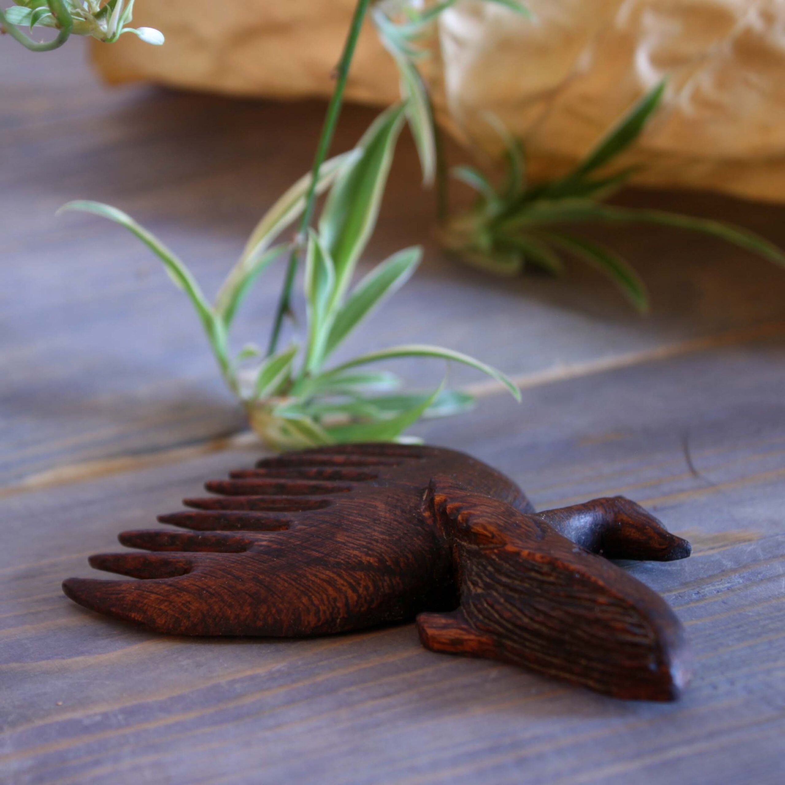 Hand-Carved Wooden Comb with Intricate Whale Design