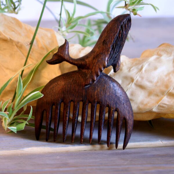 Hand-Carved Wooden Comb with Intricate Whale Design