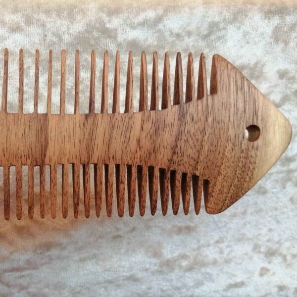 Rustic Hand-Carved Wooden Comb with Intricate Fish Design