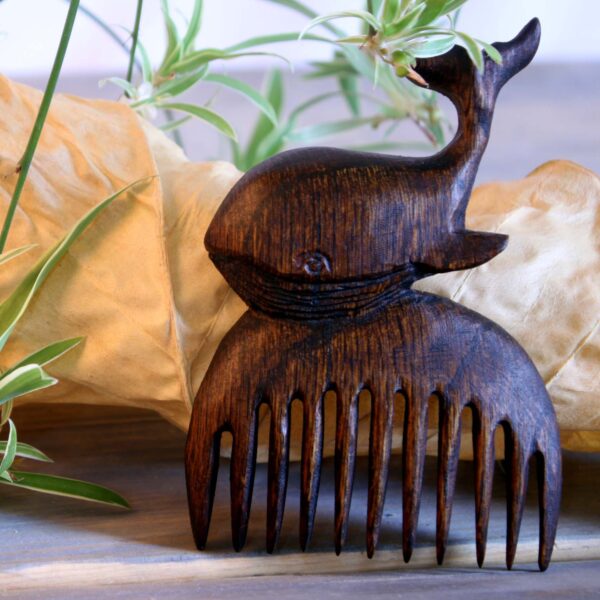 Rustic Hand-Carved Wooden Comb with Intricate Whale Design
