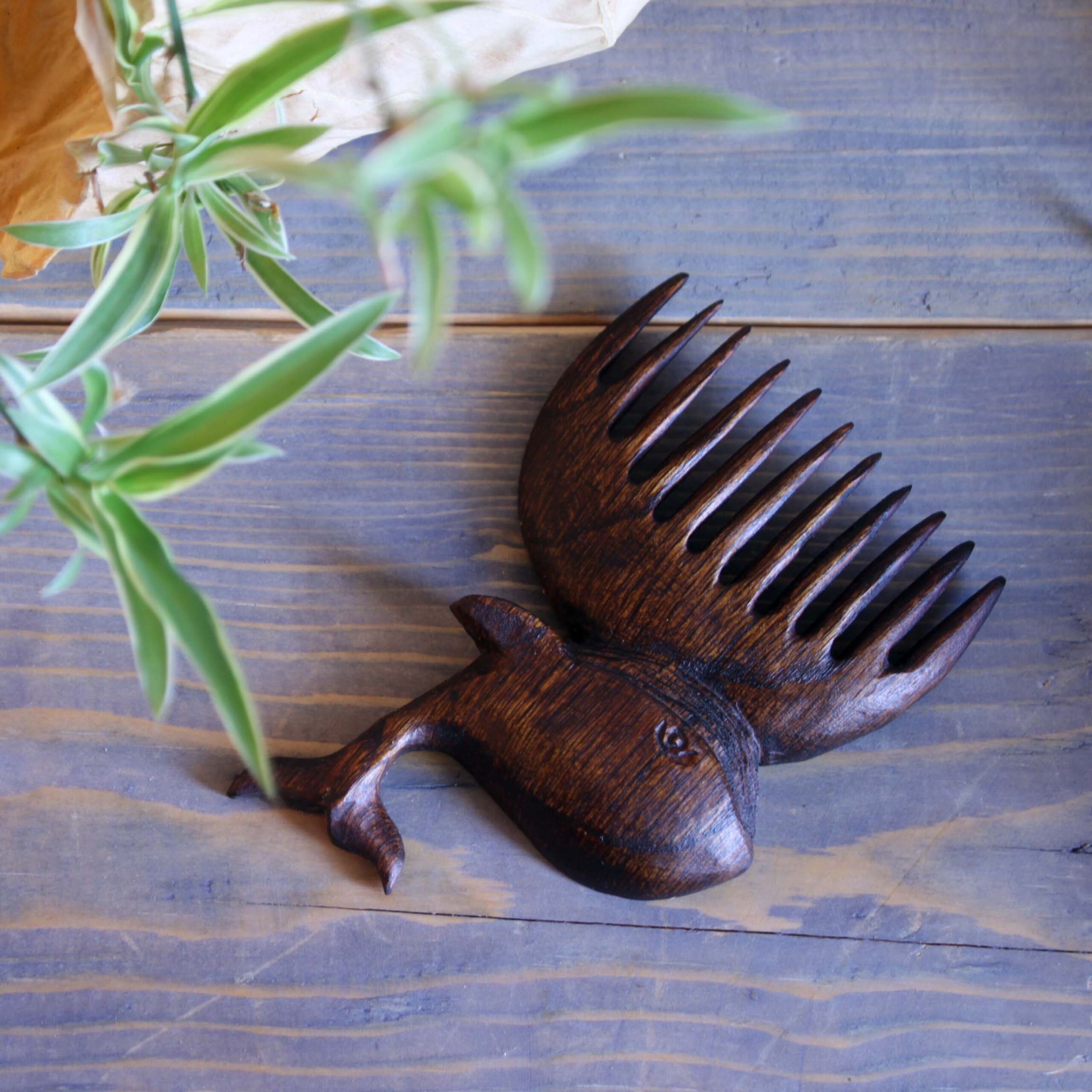 Rustic Hand-Carved Wooden Comb with Intricate Whale Design