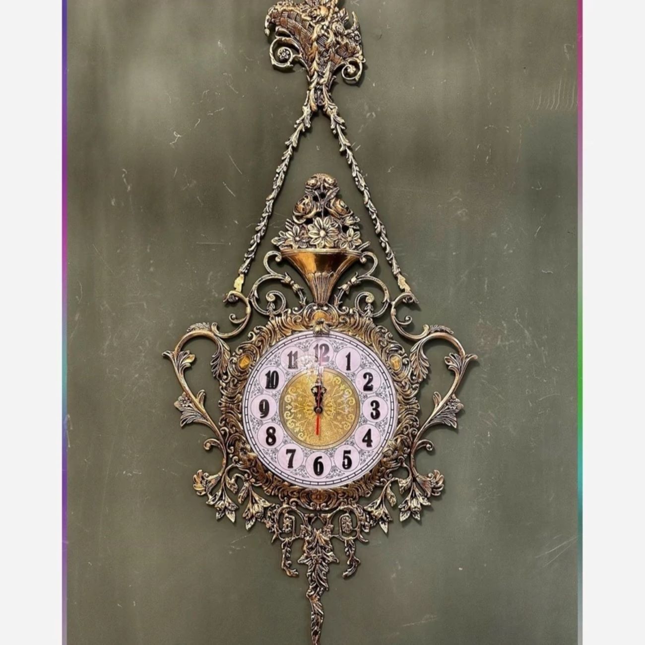 Charming Brass Wall Clock with Decorative Floral Accents and Hanging Detail