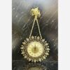Charming Brass Wall Clock with Decorative Floral Accents and Hanging Detail