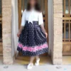 Black-Pleated-Satin-Skirt-with-White-Polka-Dots-and-Bold-Pink-Floral-Hem-3