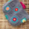 Handmade-Crochet-Granny-Square-Handbag-–-Colorful-Floral-Motif-with-Zipper-Cعlosure-and-Tassel-Detail