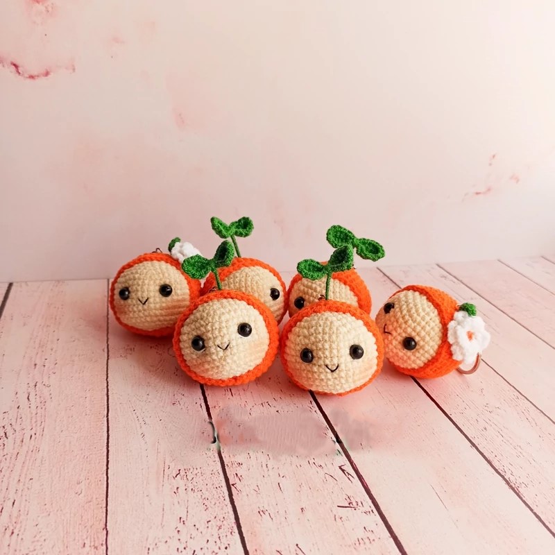 Handmade Crochet Orange Keychain – Soft Yarn Bag Charm with Green Leaf and White Blossom